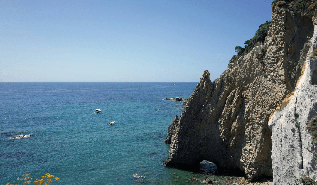 A cliffside in Italy near crystal blue water |. The Italian On Tour