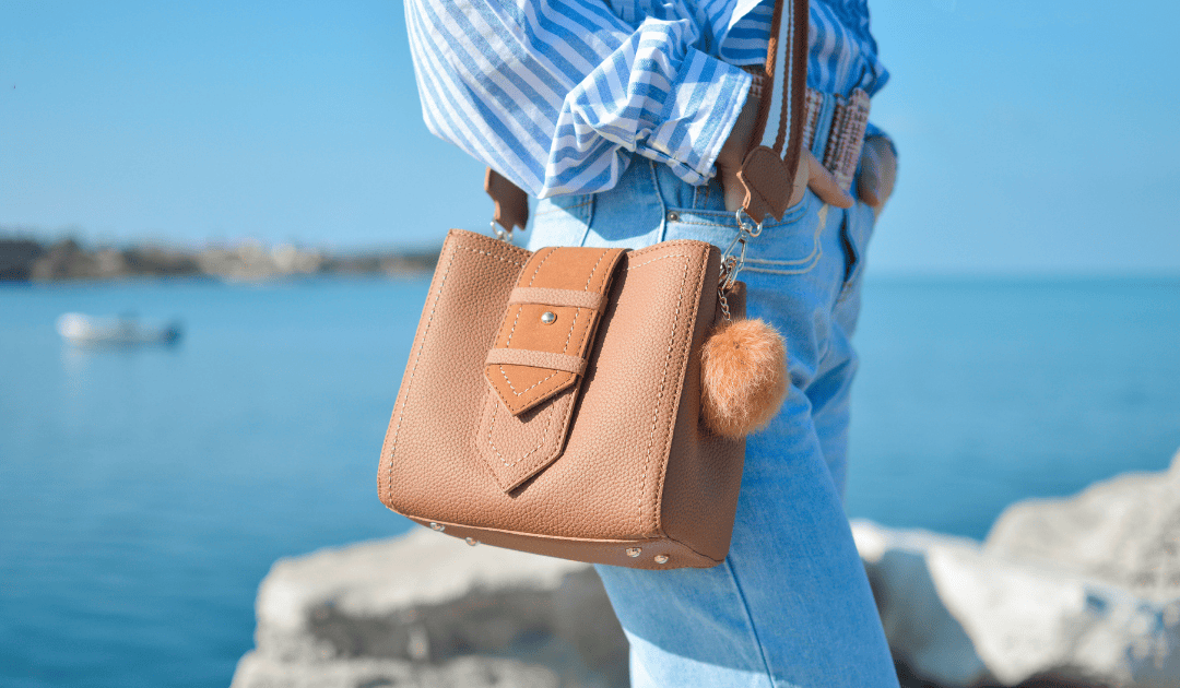 lady by the beach wearing jeans and a leather cross body bag